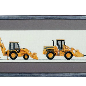 May include: A framed cross-stitch artwork featuring a line of five yellow construction vehicles, including a bulldozer, excavator, front loader, and two smaller vehicles. The vehicles are all facing the same direction and are set against a white background.