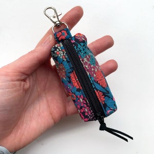 Pequeño llavero bolsa flores de color negro para accesorios como cambiar auriculares airpods bálsamo labial teclas