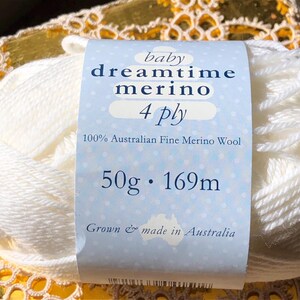 May include: A skein of white Baby Dreamtime Merino 4 ply yarn. The label reads "100% Australian Fine Merino Wool" and "50g &bull; 169m". The yarn is made in Australia.