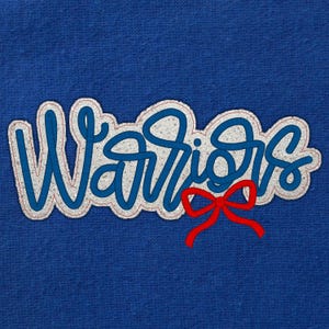 May include: A blue fabric with the word "Warriors" in a white, glittery font with blue outlines and a red bow. The word is in a cursive style, with a red outline.