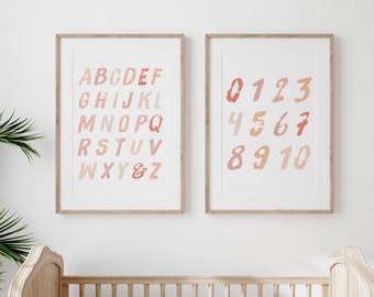 May include: Two framed prints with a white background. The left print features the alphabet in pink, orange, and red. The right print features the numbers 0-10 in the same color scheme. The text "PRET-A-PRINT" is visible at the bottom of the image.