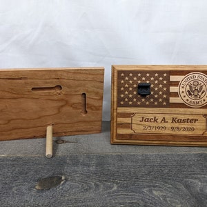May include: A wooden plaque with an American flag and the United States Army seal. The plaque is engraved with the name "Jack A. Kaster" and the dates "2/3/1929 - 9/8/2020".