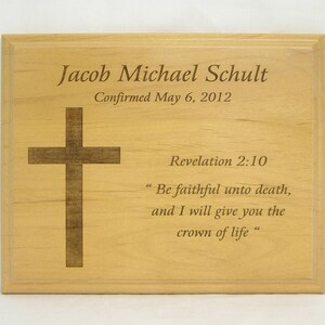 May include: A wooden plaque with a cross and the text "Jacob Michael Schult Confirmed May 6, 2012 Revelation 2:10 "Be faithful unto death, and I will give you the crown of life."
