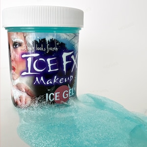 May include: A blue jar of Ice FX Makeup Ice Gel. The jar is labelled "...it only looks frozen" and "Ice FX Makeup Ice Gel". The gel is spilling out of the jar and is a light blue colour with glitter.