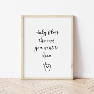 May include: A framed print with a white background and black text that reads "Only floss the ones you want to keep". A cartoon tooth with a happy face and sparkles is below the text.
