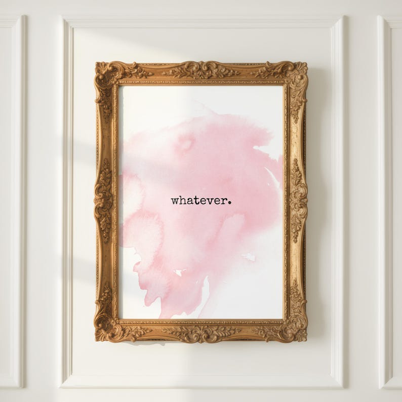 May include: A framed print with a gold ornate frame. The print features a pink watercolor design with the word "whatever" in black text. The artwork is mounted on a white wall.