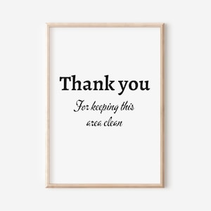 Puede incluir: Una impresión enmarcada con el texto "Gracias" y "Por mantener esta área limpia" en texto negro sobre fondo blanco.