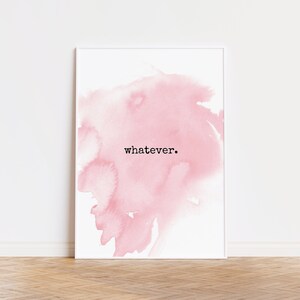 May include: White framed art print featuring a soft pink watercolor design. The word "whatever" is printed in black, centered on the artwork. The print is displayed against a white wall and a wooden floor.