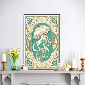 A black framed painting of an art nouveau deco style jellyfish in a turquoise, white, and gold color scheme sits on a white fireplace mantle with white candles and a vase of yellow flowers.
