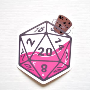 May include: A pink 20-sided die shaped like a potion bottle with a cork stopper. The die has black numbers and a black outline.