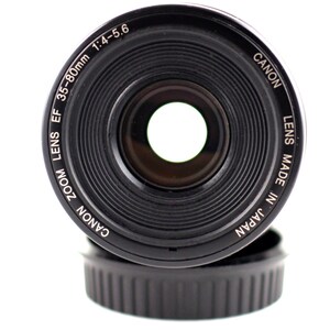 May include: A black Canon zoom lens with the text "Canon Zoom Lens EF 35-80mm 1:4-5.6 Lens Made in Japan" printed around the edge.