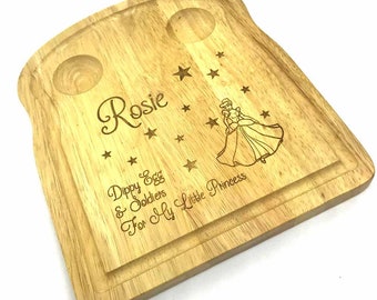 May include: A wooden breakfast tray with two egg cups, a princess illustration, and the text "Rosie Dippy Egg & Soldiers For My Little Princess".