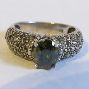 Fine sterling ring embellished with marcasites and central peridot