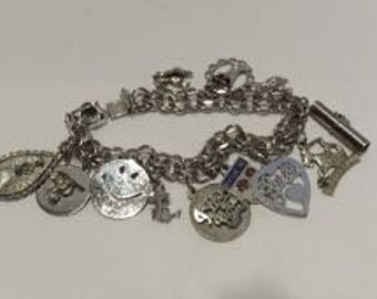 Vintage 1950's sterling silver charm bracelet with 12 sterling charms