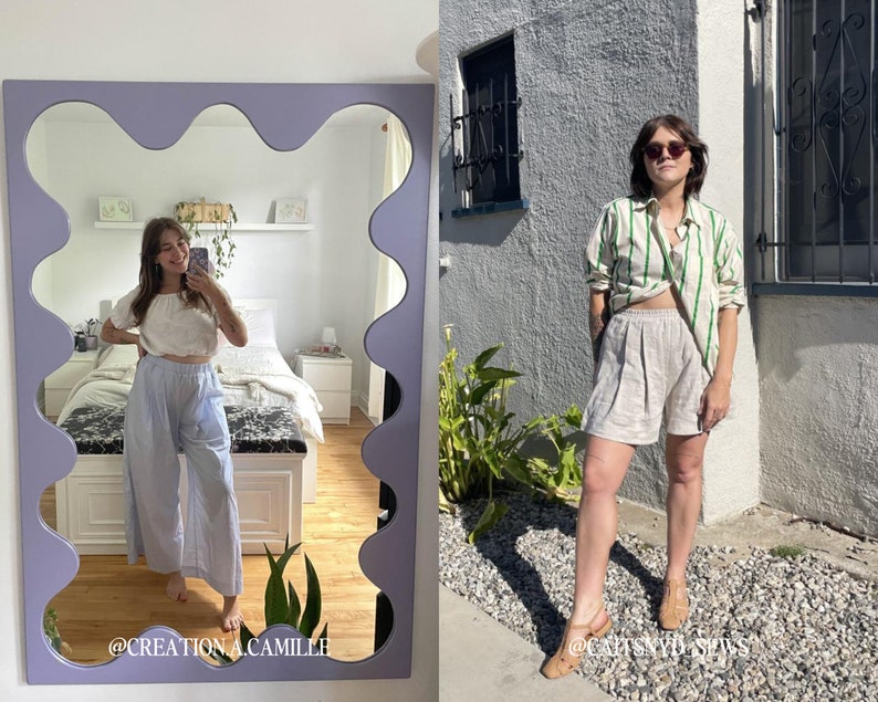 May include: A woman wearing a white and green striped shirt with a white top underneath and beige linen shorts. She is standing in front of a brick wall with green plants in the background. The text "@CAPTSYDBSPWS" is visible in the bottom right corner of the image.