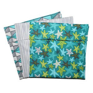 May include: Three fabric pouches with different patterns. One has a geometric teal and gray design, another has gray and white stripes, and the third features a teal background with starfish in various colors. These pouches are likely for storage or travel.