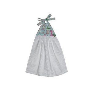 May include: White kitchen towel with a blue and white patterned fabric top. The fabric top has a loop for hanging and a bow.