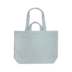 May include: A light blue tote bag with a white polka dot pattern and red and white patterned handles.