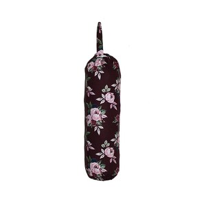 May include: A maroon wine bottle bag with a floral pattern of pink roses and green leaves. The bag has a long, narrow shape with a loop at the top. The floral design is repeated across the entire surface of the bag.