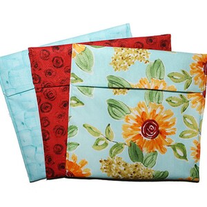 May include: Three fabric snack bags, one with a red floral pattern, one with a blue floral pattern, and one with a light blue floral pattern.