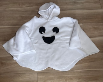 May include: White fleece ghost costume with a black smiling face. The costume has a hood and long sleeves.
