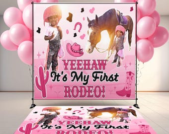 May include: A pink rodeo-themed backdrop and floor mat set with the text "YEEHAW It's My First RODEO!" features a cartoon horse, cowboy hat, and boots. Pink balloons are on the left and right. The backdrop has a black stand.