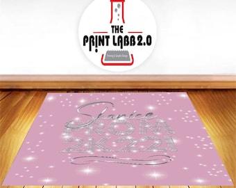 May include: Pink backdrop with silver glitter lettering that reads "Shanice Prom 2021". The backdrop is decorated with silver glitter stars.