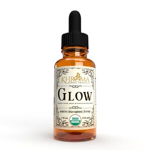 May include: A 2 fl oz amber glass bottle with a dropper top. The bottle is labeled with a gold and white design that says "KHROMA HERBAL PRODUCTS GLOW HERBAL HAIR, SKIN, & NAILS SUPPLEMENT alcohol-free | dietary supplement | 30 servings 2 fl oz USDA ORGANIC (59 ml)"