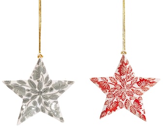 May include: Two ceramic star ornaments with a gold string for hanging. One star is white with a gray floral pattern and the other is white with a red floral pattern.