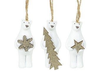 May include: Three white ceramic polar bear ornaments with gold glitter accents. Each bear is holding a different holiday-themed decoration: a snowflake, a Christmas tree, and a star.