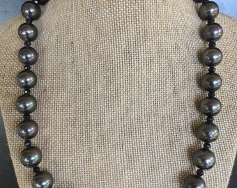 Unique and rare necklace of black mother of pearl & spinel, set in Sterling silver. One of a kind jewelry creation offering endless beauty!