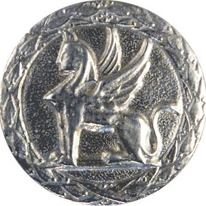 May include: A silver-toned coin with a winged lion or griffin in the center, surrounded by a wreath of leaves.