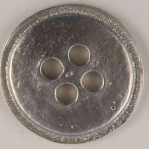 May include: A silver metal button with five holes in a circular pattern.