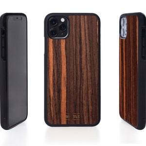 May include: A black phone case with a wood grain pattern. The case has a raised camera bump and a black trim around the edges.