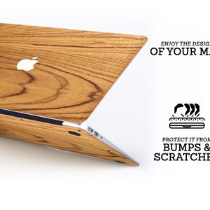 May include: A wood-grain laptop skin with a silver Apple logo. The text "Enjoy the design of your Mac" and "Protect it from bumps & scratches" is printed on a white background.