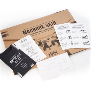 May include: A brown cardboard envelope with the text "MACBOOK SKIN" and "For those who love nature". The envelope contains instructions on how to apply and remove a Macbook skin, a warranty card, and a note that says "Thank you for your order".