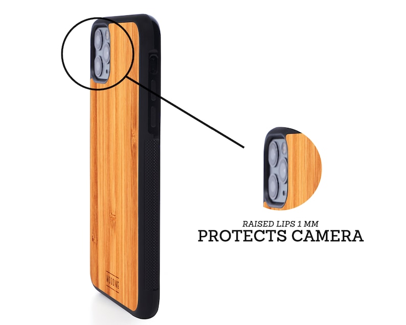 May include: A brown wood phone case with a black border and a raised lip around the camera lens. The case is made of bamboo and has a natural wood grain. The text "RAISED LIPS 1 MM PROTECTS CAMERA" is printed on the case.