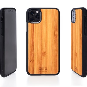 May include: A brown wood iPhone case with a black border and the word "WOODWEE" printed on the back.