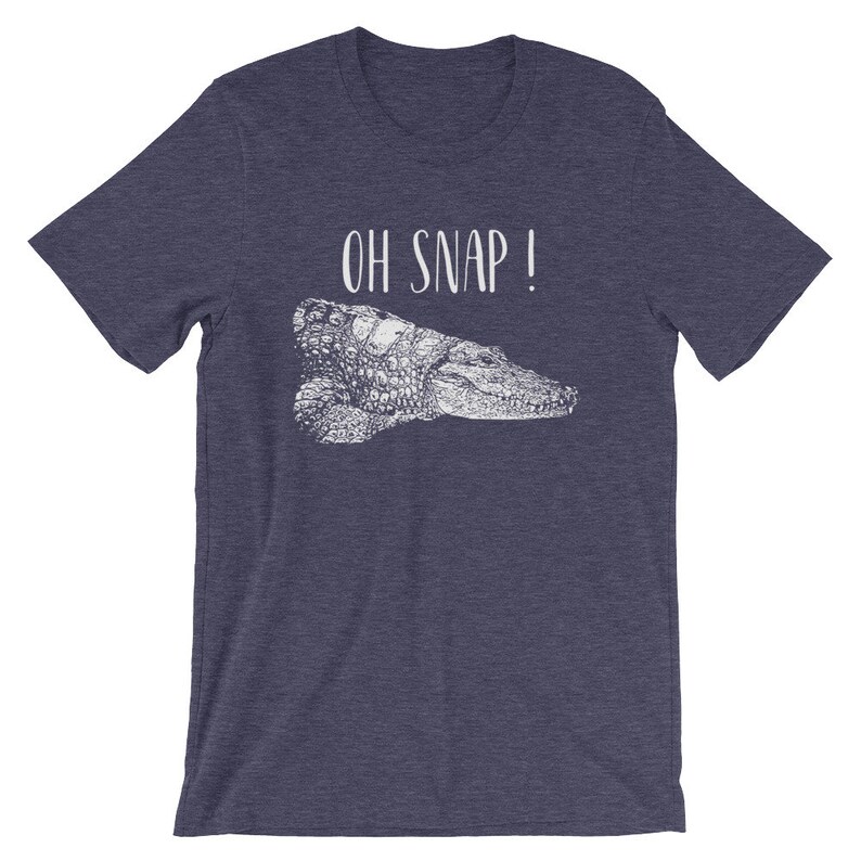 May include: A navy blue t-shirt with a white alligator graphic and the text "OH SNAP!" printed on the front.