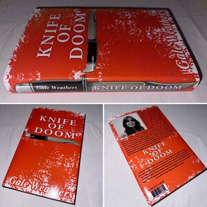 May include: A red paperback book with a white distressed background. The book cover features a knife and the title "Knife of Doom" in white text. The author's name, "Gale Weathers", is printed in white text at the bottom of the cover.