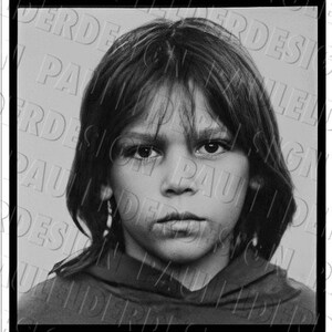 May include: Black and white missing person poster with a photo of a young person with long hair. The poster says "MISSING" in bold black letters and "Laddie" Thompson, b 6-20-76, HT, 4FT WT, 50LBS. The poster also includes contact information for the Santa Carla County Sheriff's Department Missing Persons, 1804 555-5911.