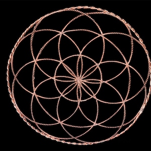 May include: A copper wire flower of life mandala with a twisted wire design. The mandala is circular and has a geometric pattern.