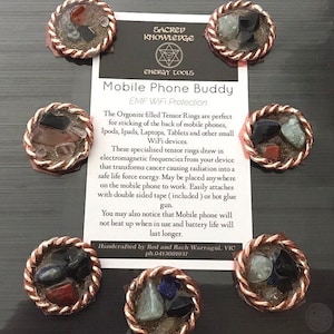 May include: Orgonite filled Tensor Rings for EMF protection. These rings are designed to transform electromagnetic frequencies into safe life force energy. They can be placed on mobile phones, laptops, tablets, and other devices. The rings are handcrafted and come with double-sided tape for easy attachment.