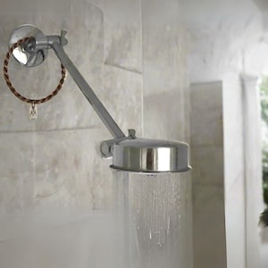 May include: A chrome shower head with a long arm extending from the wall. The shower head is spraying water.