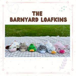 May include: A collection of six crocheted farm animal loafkins, including a cow, horse, duck, sheep, and pig, arranged on a checkered blanket. The text "THE BARNYARD LOAFKINS" is displayed above the animals. The background is a green lawn.