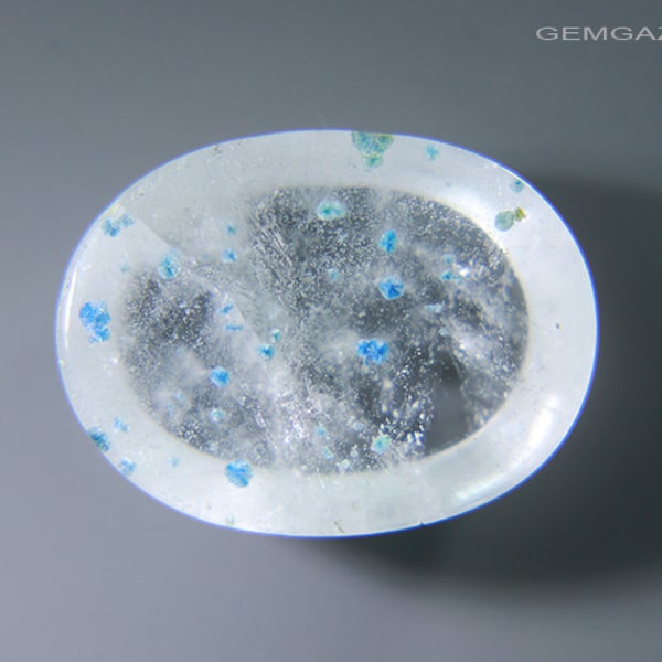 Quartz cabochon with blue & green Gilalite inclusions, Brazil. 4.71 carats.