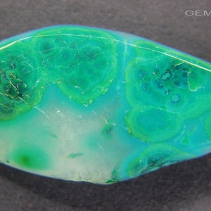 May include: A green and white cabochon gemstone with a unique, swirling pattern. The gemstone is cut in a teardrop shape and has a smooth, polished surface.