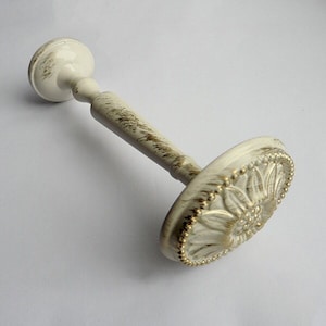 May include: White metal curtain rod finial with a gold floral design and a beaded edge.