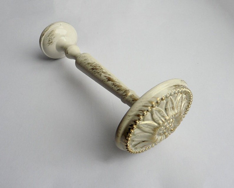 May include: White metal curtain rod finial with a gold floral design and a beaded edge.