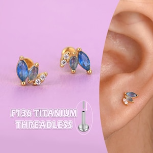 Piercing labret in titanio a fondo piatto: zirconi a marquise, per conchiglia, elice e trago.